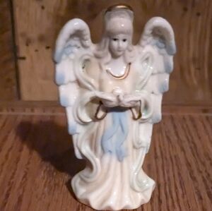 Small Guardian Angel holding a bird